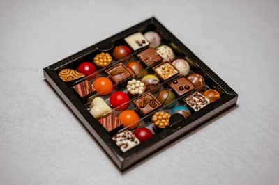 A box of glossy moulded chocolate bonbons