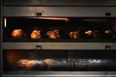 Loaves rising in a hot oven during the first minutes of baking
