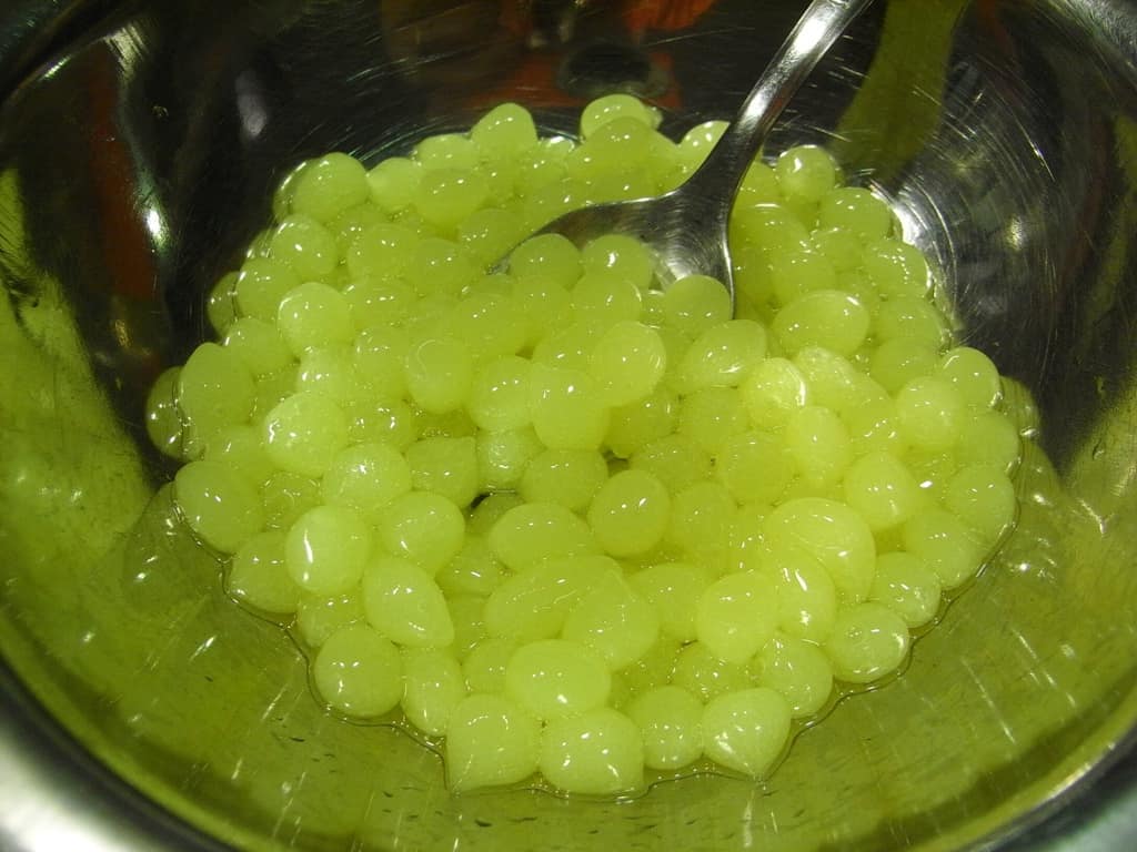 Tiny green spheres made by spherification